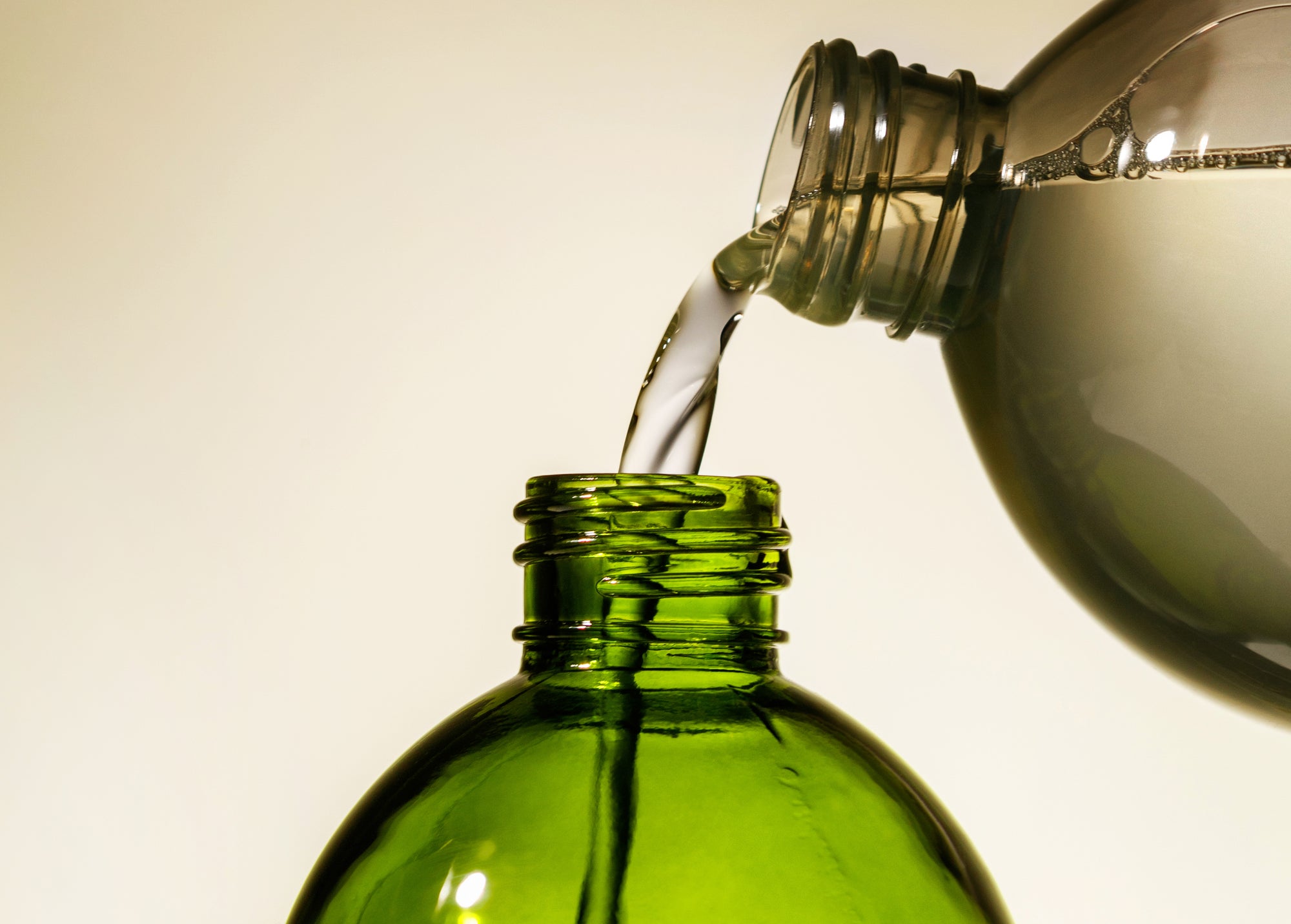 Cleaning product being poured into a glass bottle